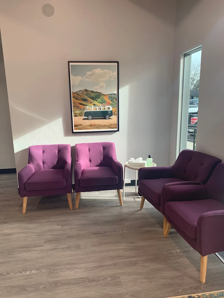 Waiting room with four purple chairs and wall art at Northpoint Imagine Boise