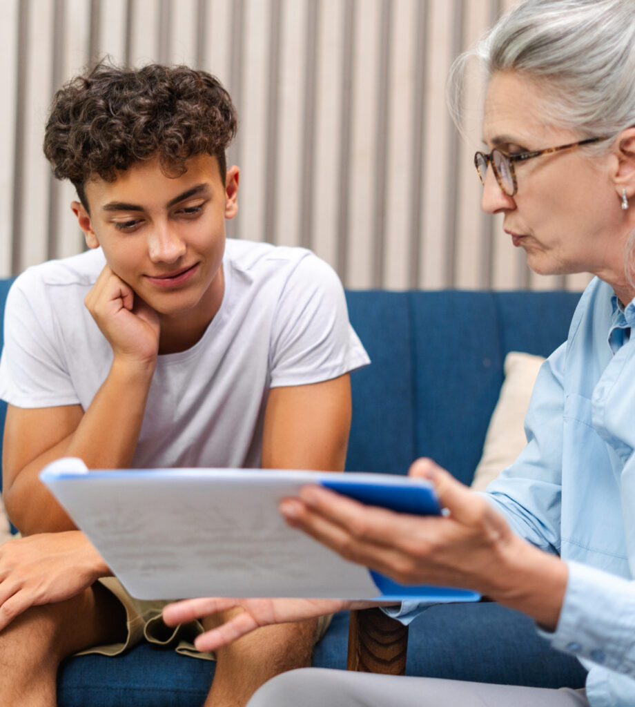 Boy being shown papers by his counselor